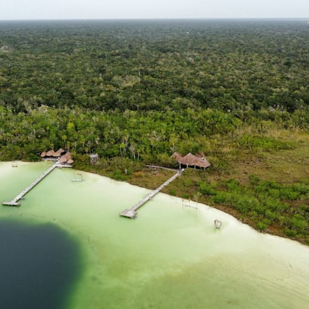 Aerial view of Laguna Kaan Luum with turquoise water and jungle canopy near Tulum