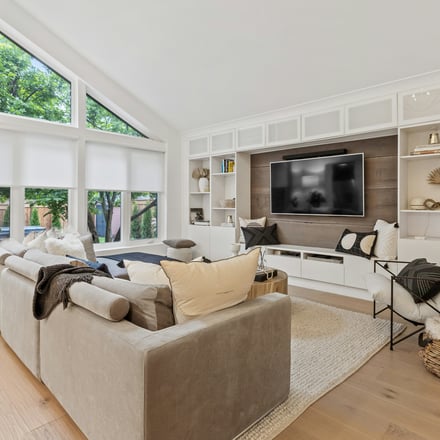 Spacious living room with built-in shelving and natural light
